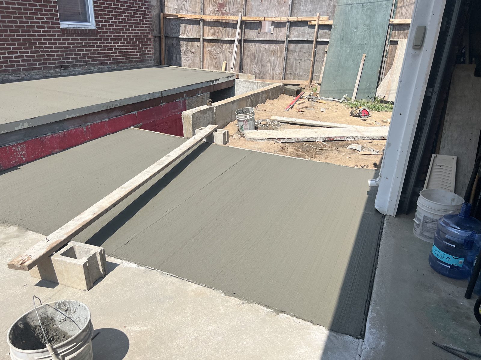 JBS new stoop and entry slab concrete pour at NYC brick rowhouse
