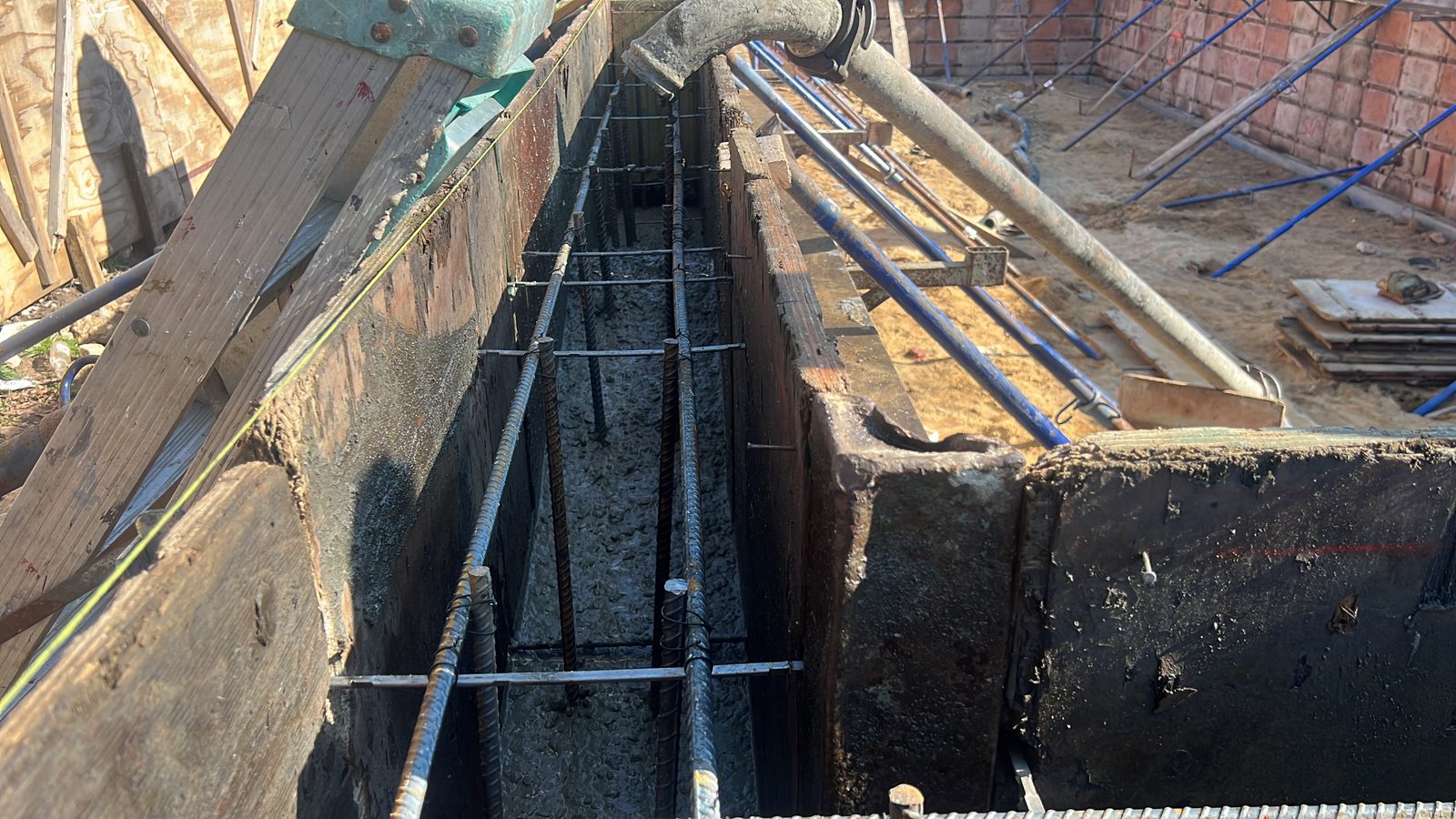 JBS new construction concrete foundation pour with rebar cage and form pump