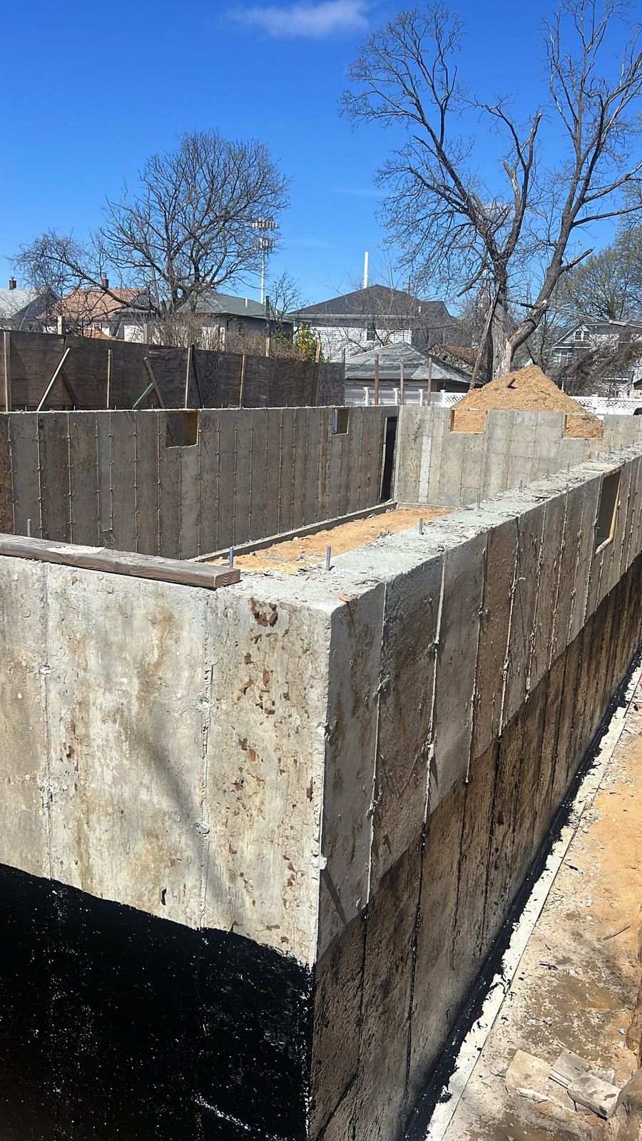 JBS foundation waterproofing with bituminous coating applied to poured concrete walls